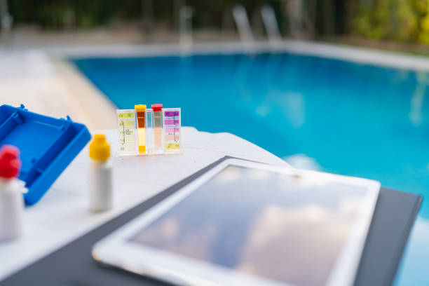 A tablet computer sitting on top of a table next to a pool